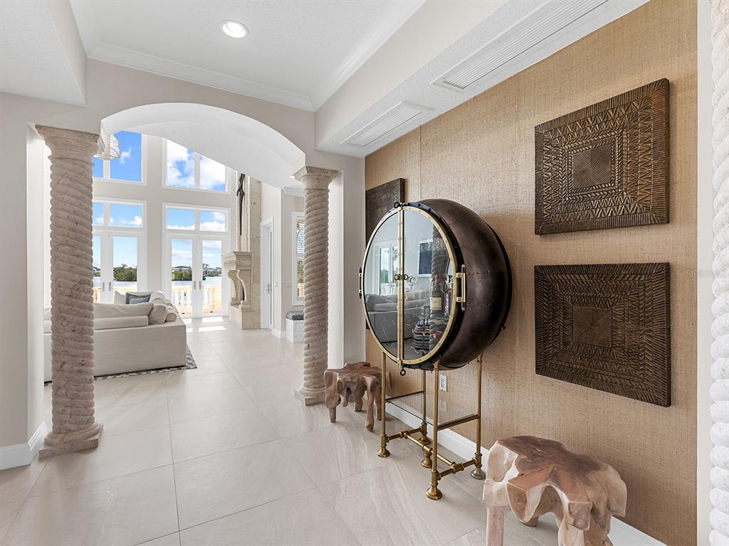 144 North Casey Key Road Nokomis, FL 34275 - Photo 12 of 54 a living room with furniture a mirror and a fireplace