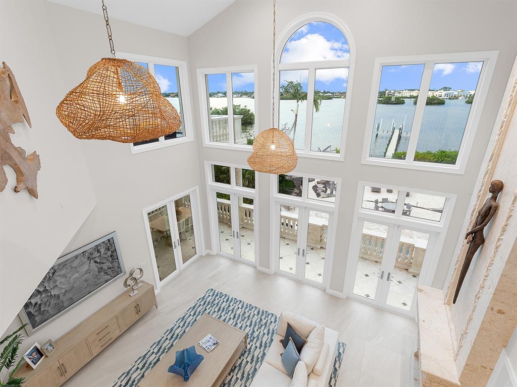 144 North Casey Key Road Nokomis, FL 34275 - Photo 15 of 54 a living room with furniture and a floor to ceiling window
