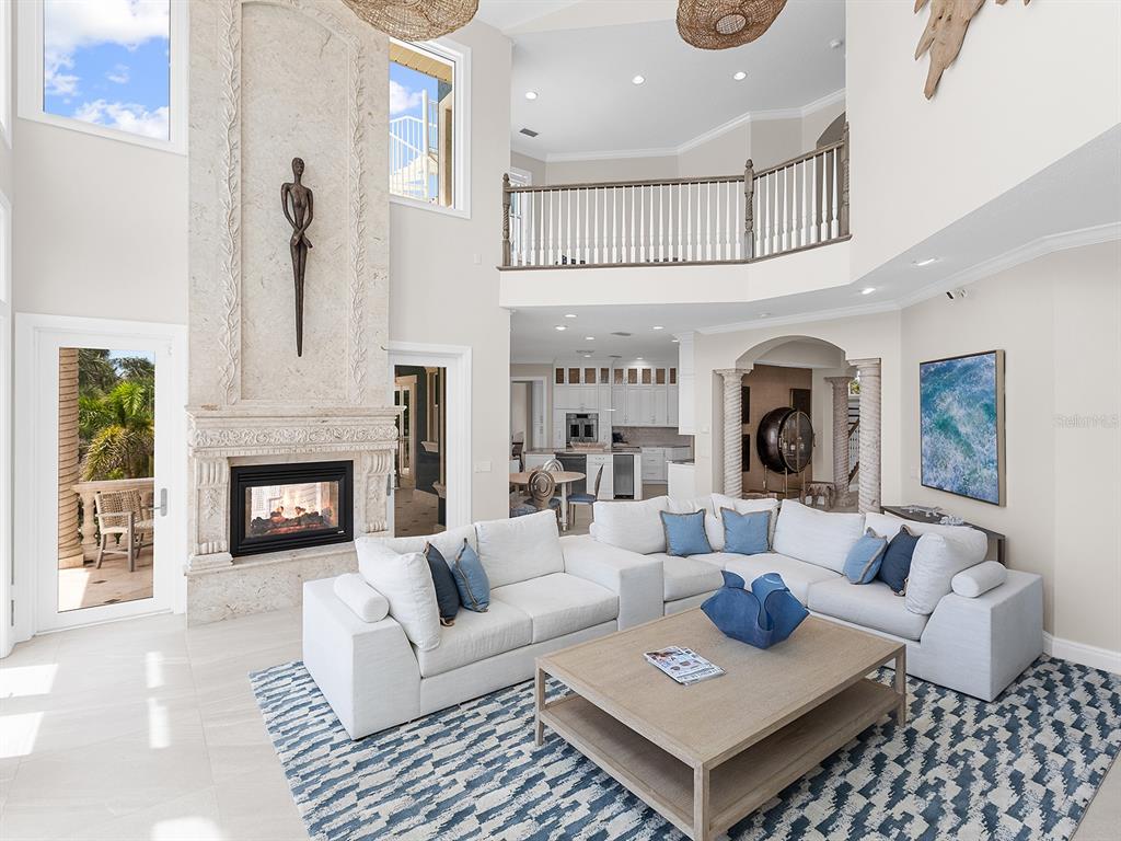 144 North Casey Key Road Nokomis, FL 34275 - Photo 16 of 54 a living room with furniture and a fireplace