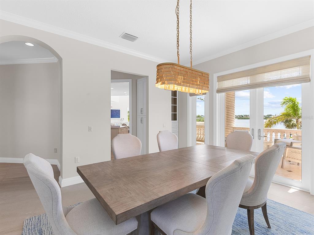 144 North Casey Key Road Nokomis, FL 34275 - Photo 21 of 54 a view of a dining room with furniture window and wooden floor