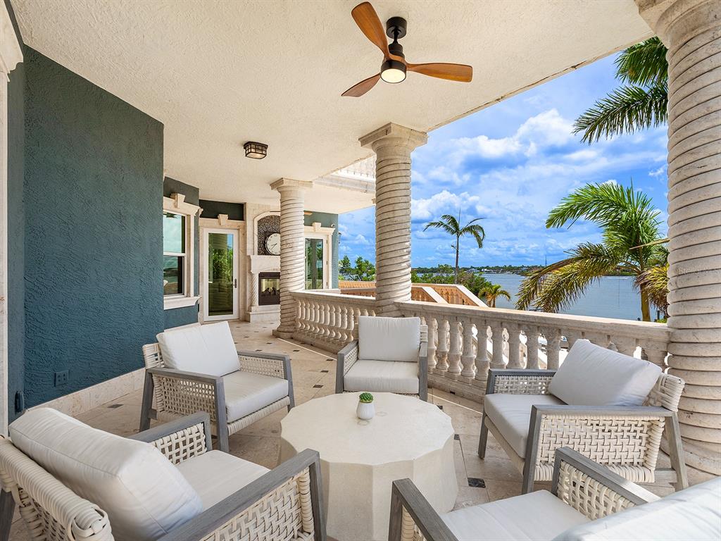 144 North Casey Key Road Nokomis, FL 34275 - Photo 22 of 54 a view of a patio with a dining table and chairs with wooden floor