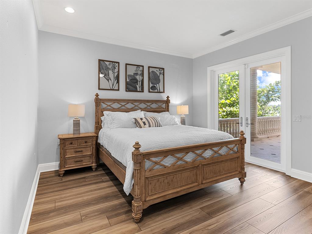 144 North Casey Key Road Nokomis, FL 34275 - Photo 24 of 54 a bed sitting in a bedroom next to a window