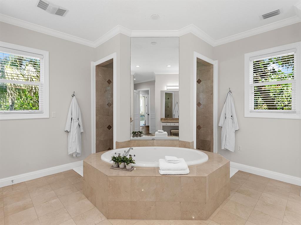 144 North Casey Key Road Nokomis, FL 34275 - Photo 26 of 54 a living room with a couch and a large window