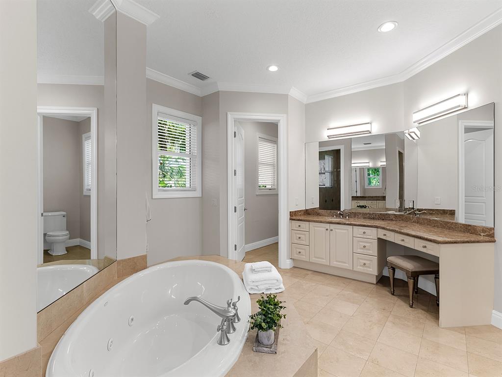 144 North Casey Key Road Nokomis, FL 34275 - Photo 27 of 54 a large spacious bathroom with a granite countertop tub sink and mirror