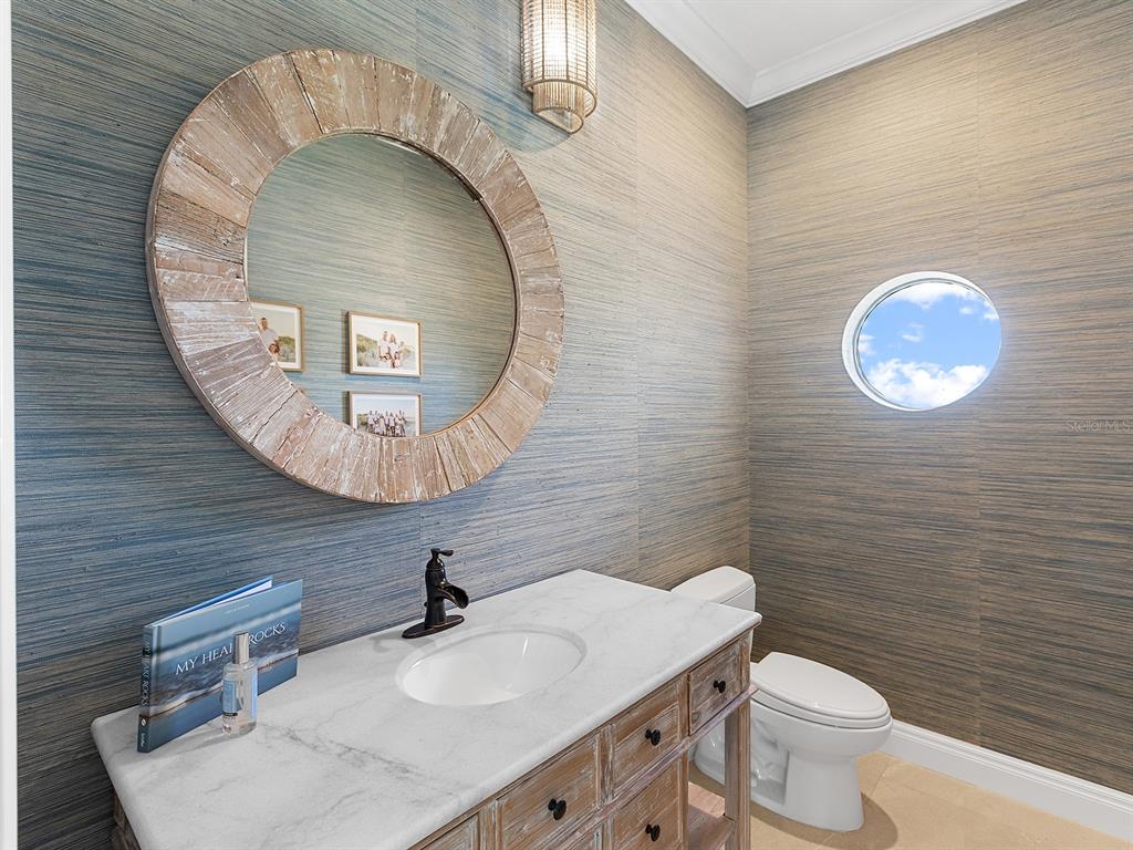 144 North Casey Key Road Nokomis, FL 34275 - Photo 28 of 54 a bathroom with a sink and a mirror