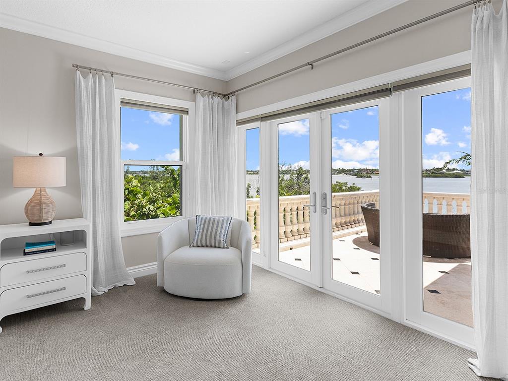 144 North Casey Key Road Nokomis, FL 34275 - Photo 34 of 54 a living room with furniture and a floor to ceiling window