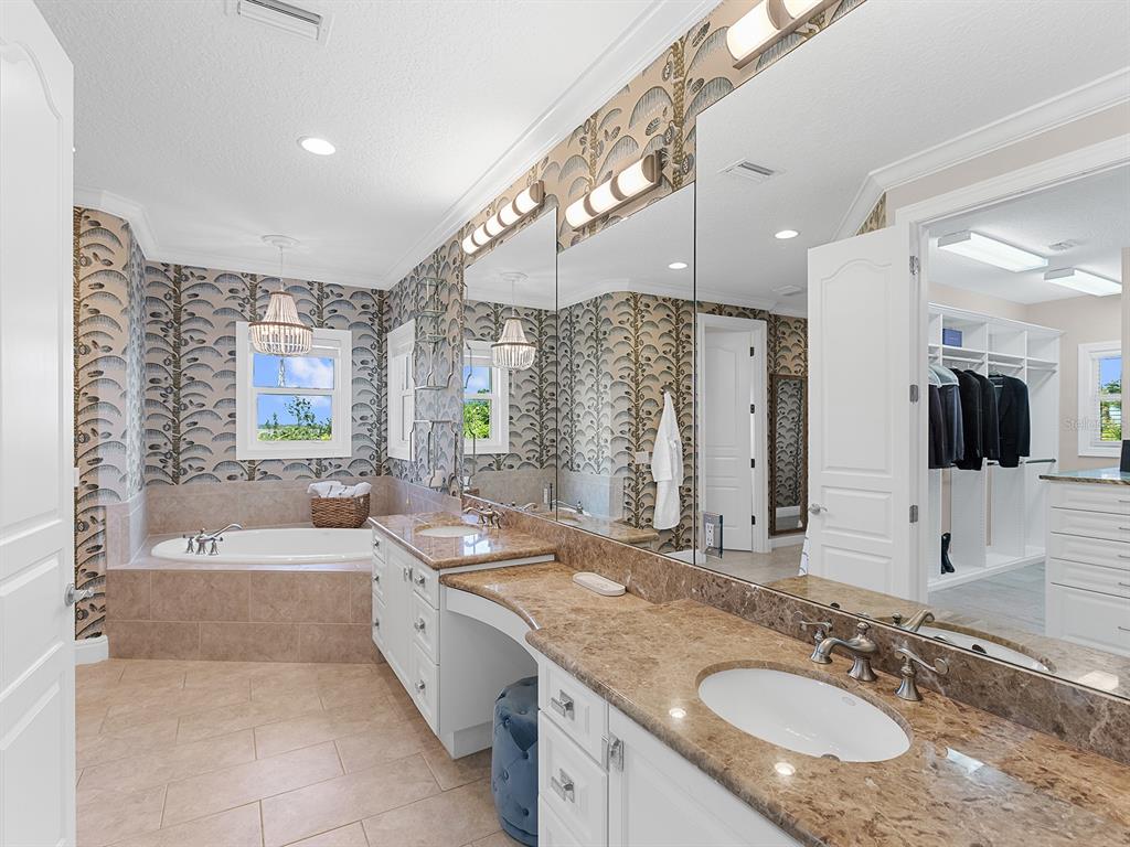 144 North Casey Key Road Nokomis, FL 34275 - Photo 35 of 54 a bathroom with a granite countertop tub sink and mirror
