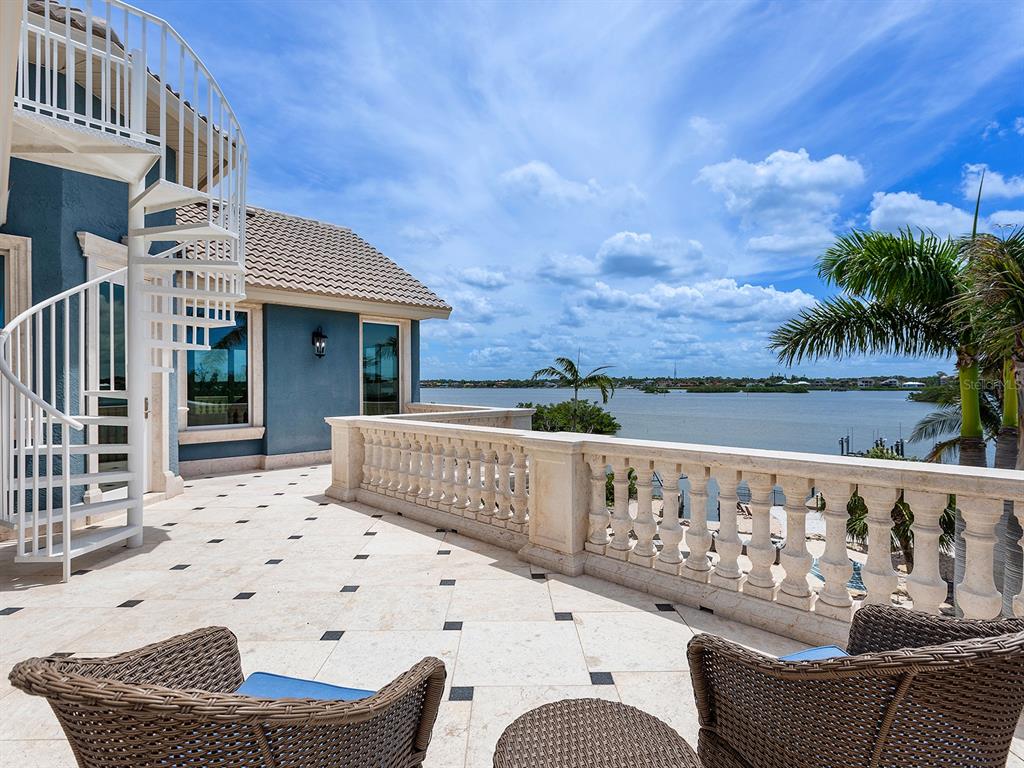 144 North Casey Key Road Nokomis, FL 34275 - Photo 37 of 54 a view of a roof deck with couches and wooden floor