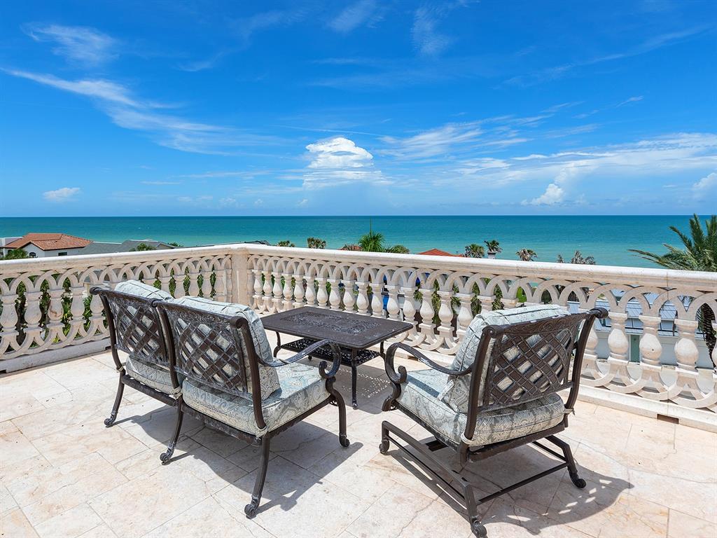 144 North Casey Key Road Nokomis, FL 34275 - Photo 41 of 54 a view of a patio with a table and chairs