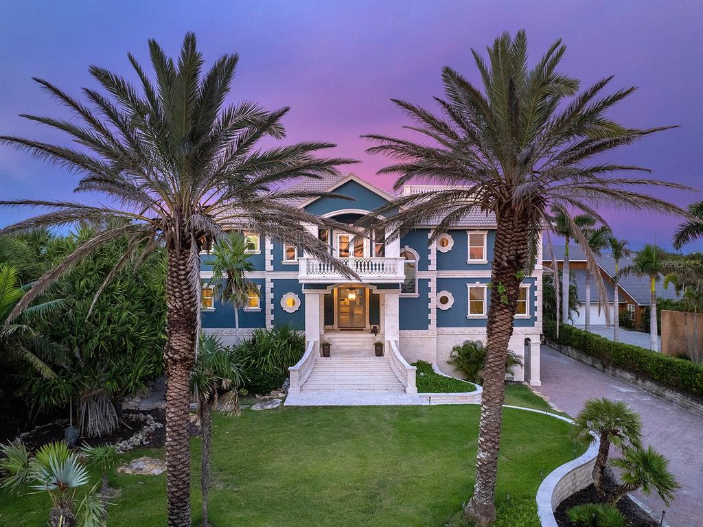 144 North Casey Key Road Nokomis, FL 34275 - Photo 7 of 54 a front view of a house with a garden