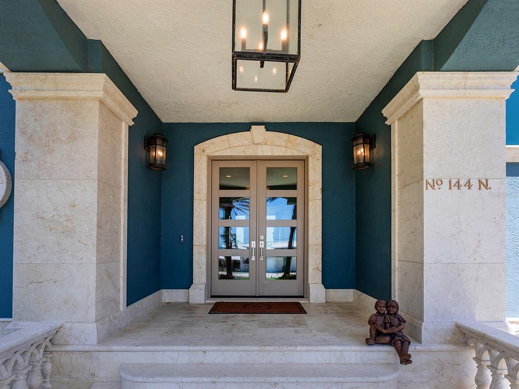 144 North Casey Key Road Nokomis, FL 34275 - Photo 9 of 54 a view of a hallway with wooden floor and a living room