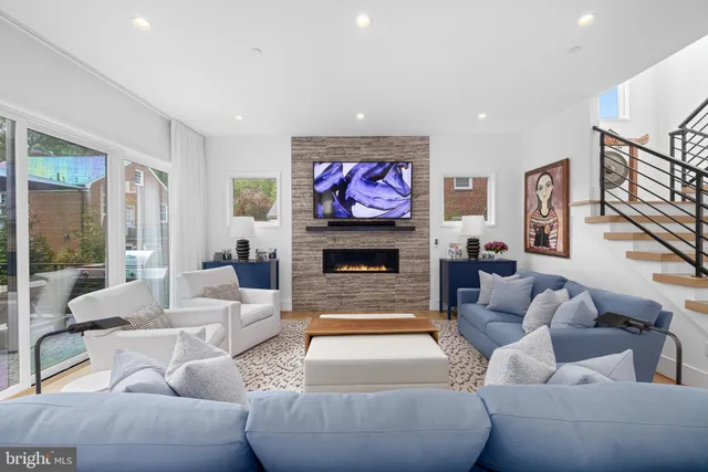 a living room with fireplace furniture and a fireplace
