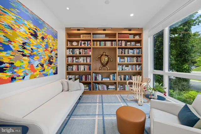 a large kitchen with kitchen island a dining table chairs and a wooden floor