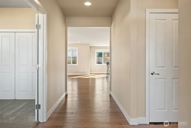 a view of a hallway with wooden floor