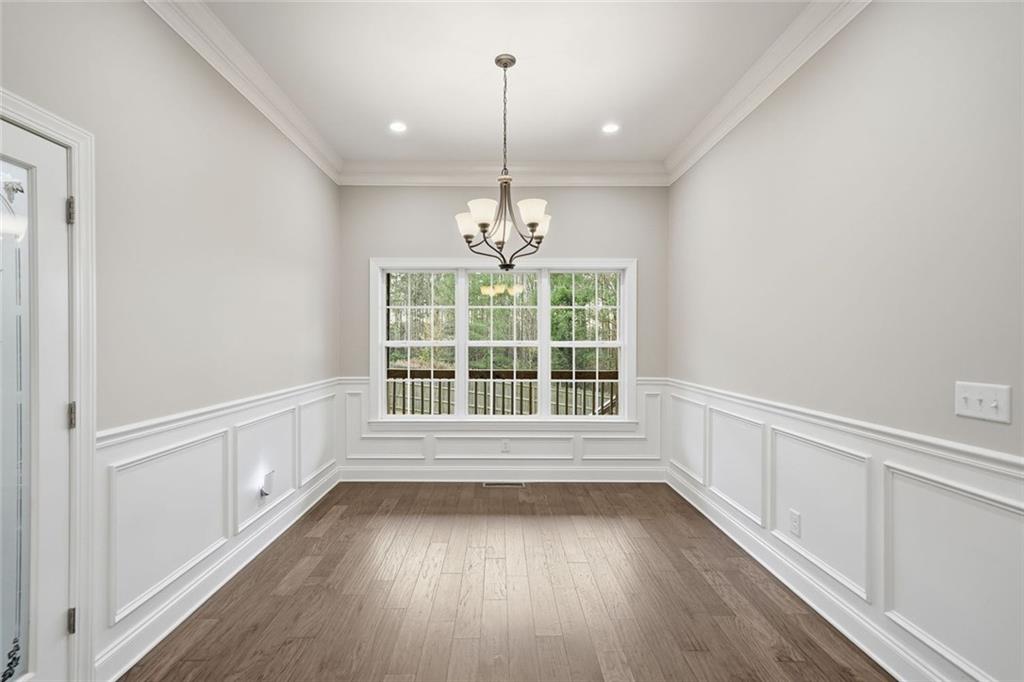 1006 Owens Store Road Canton, GA 30115 - Photo 14 of 48 a view of an empty room with wooden floor and a window