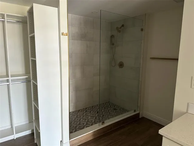 a bathroom with a glass shower door