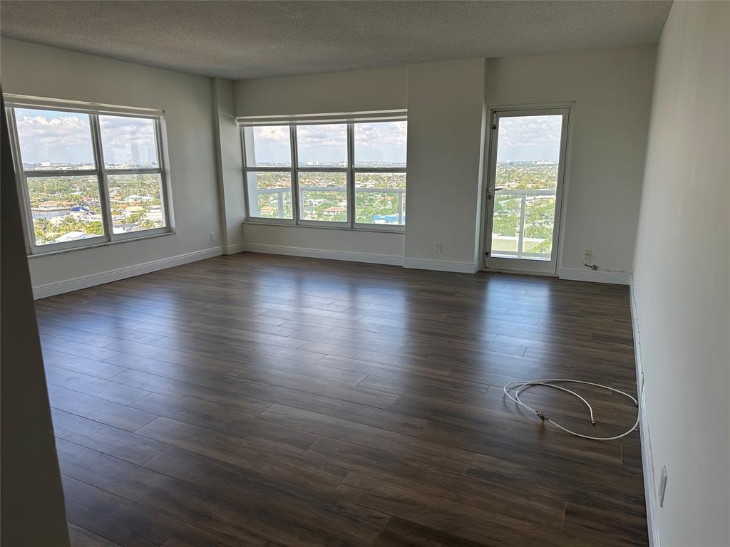 3550 Galt Ocean Drive, Unit 1907 Fort Lauderdale, FL 33308 - Photo 2 of 28 an empty room with wooden floor and windows