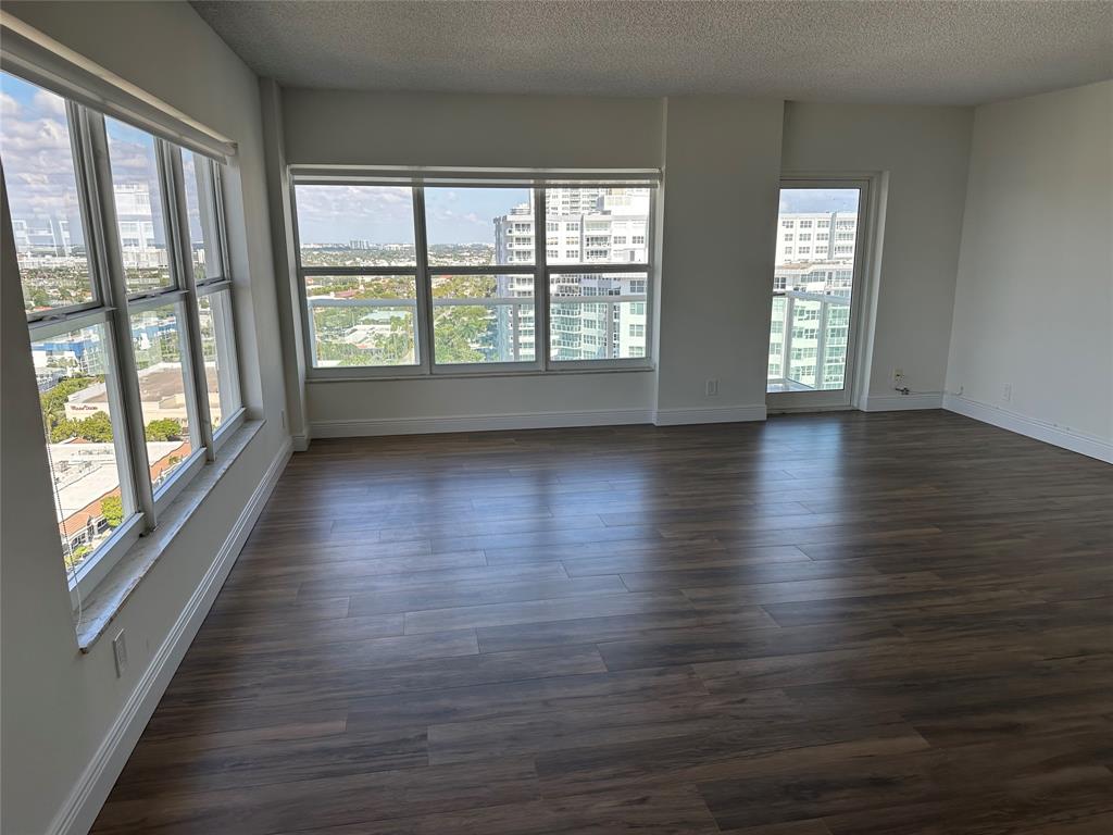 3550 Galt Ocean Drive, Unit 1907 Fort Lauderdale, FL 33308 - Photo 3 of 28 a view of an empty room with wooden floor and a window