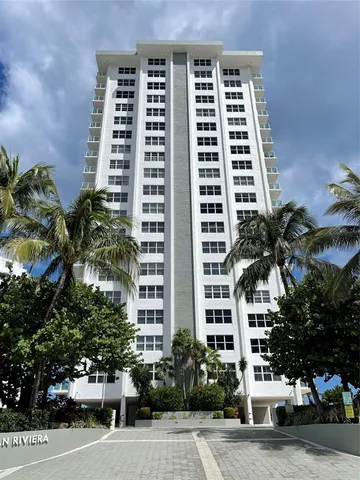 a front view of a building with palm tree