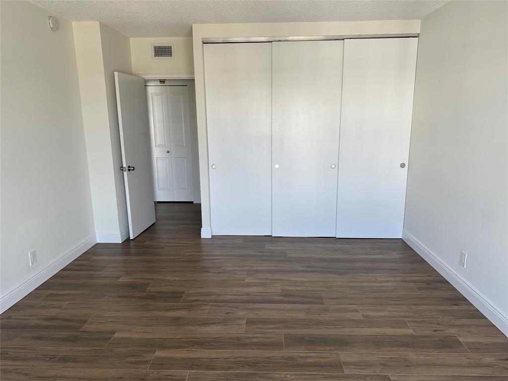 3550 Galt Ocean Drive, Unit 1907 Fort Lauderdale, FL 33308 - Photo 10 of 28 a view of an empty room with wooden floor and a window
