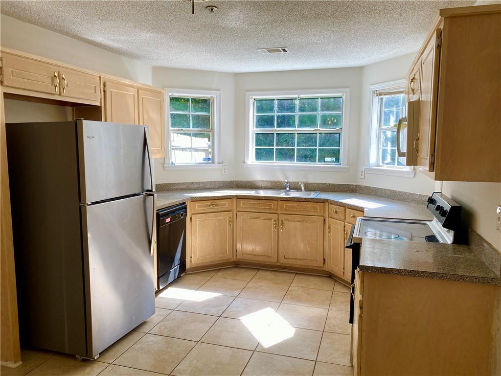 a kitchen with a stove a sink and a refrigerator