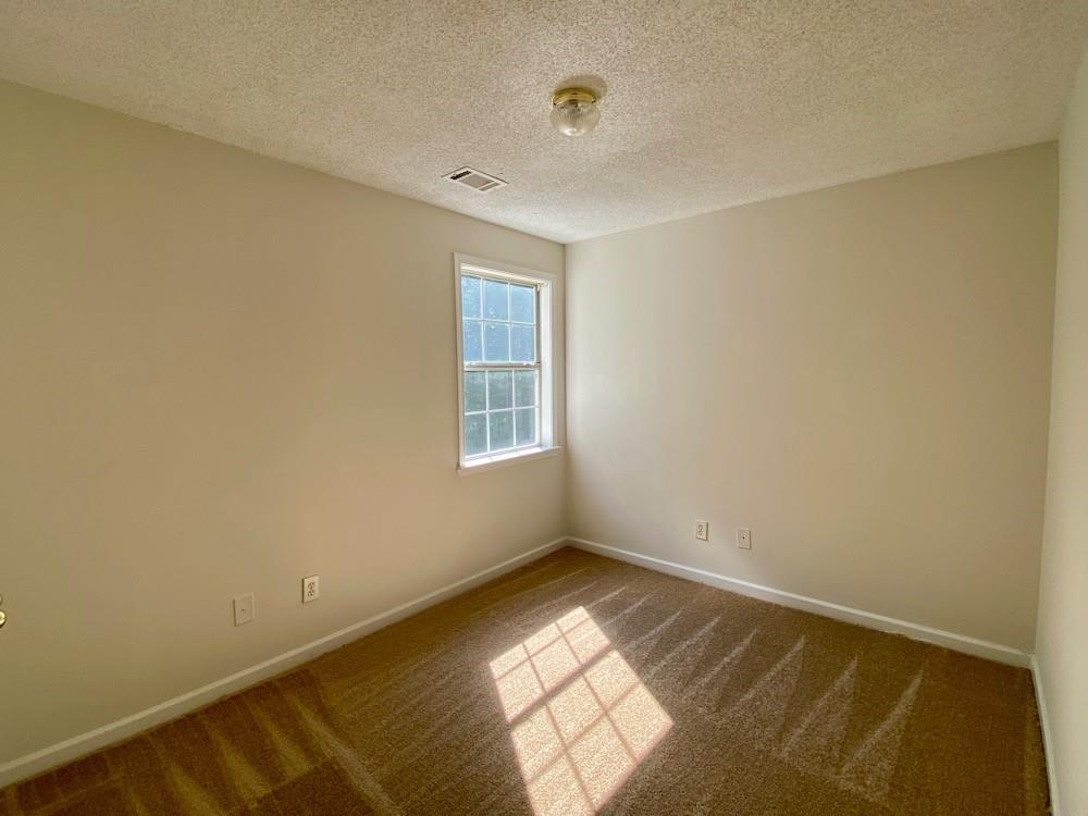 3808 Soapstone Road Decatur, GA 30034 - Photo 6 of 11 a view of empty room with wooden floor and fan