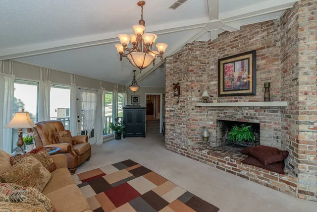 a living room with furniture a fireplace and a table