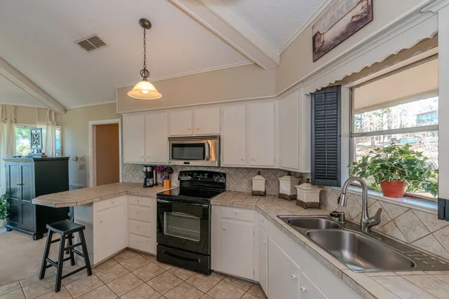 a bedroom with two beds and a chandelier