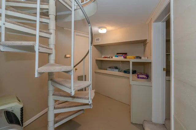a living room with furniture and a ceiling fan
