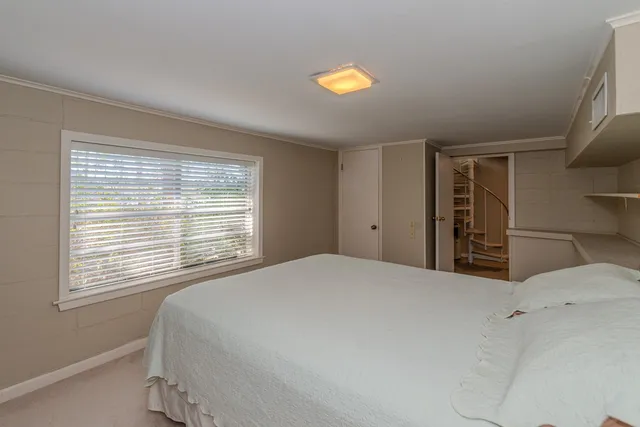a living room with furniture a dining table and a fireplace