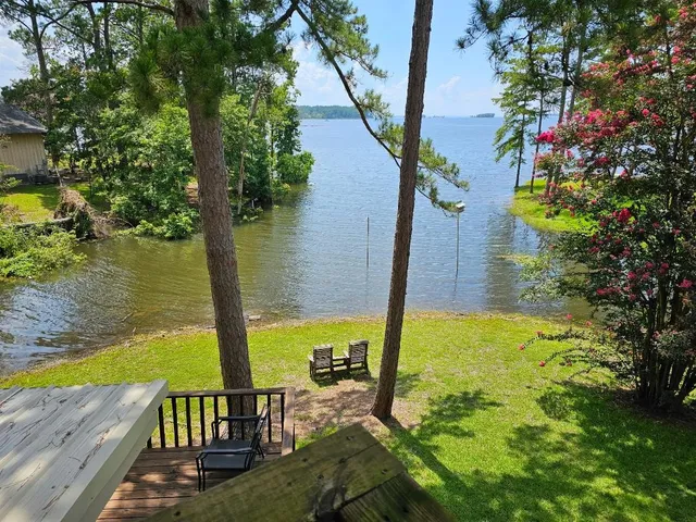 a view of a wooden deck and a garden