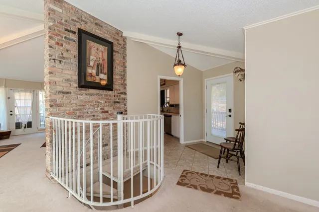 a living room with furniture a chandelier and a large window