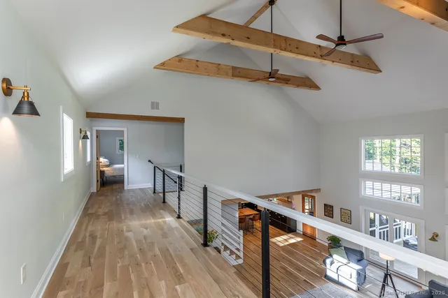 a view of a hallway with the wooden floor and staircase