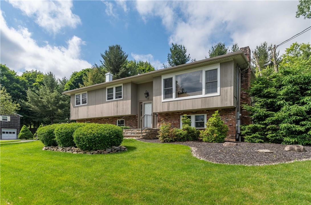 Split foyer home featuring a front yard