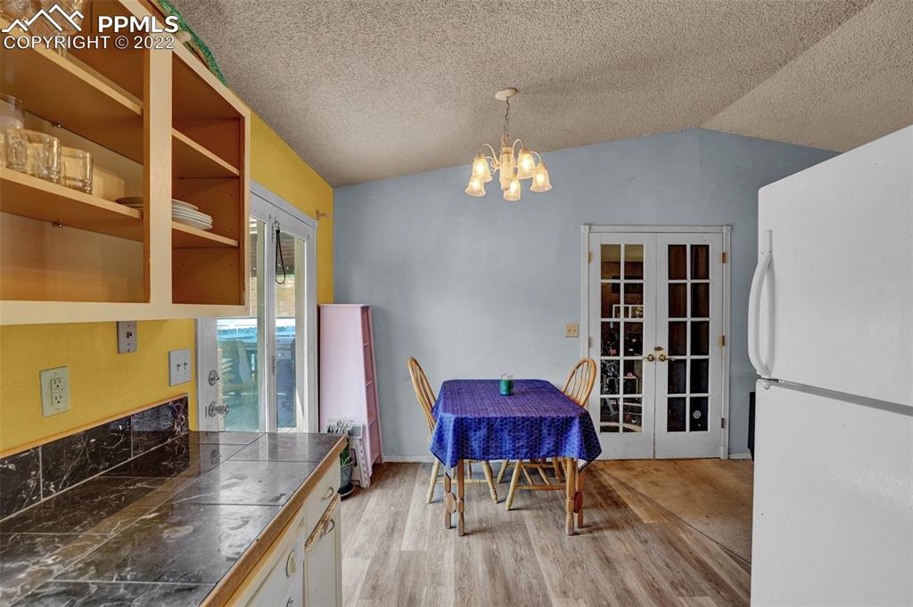 629 Blossom Field Road Fountain, CO 80817 - Photo 11 of 25 a view of a dining room with furniture and a chandelier