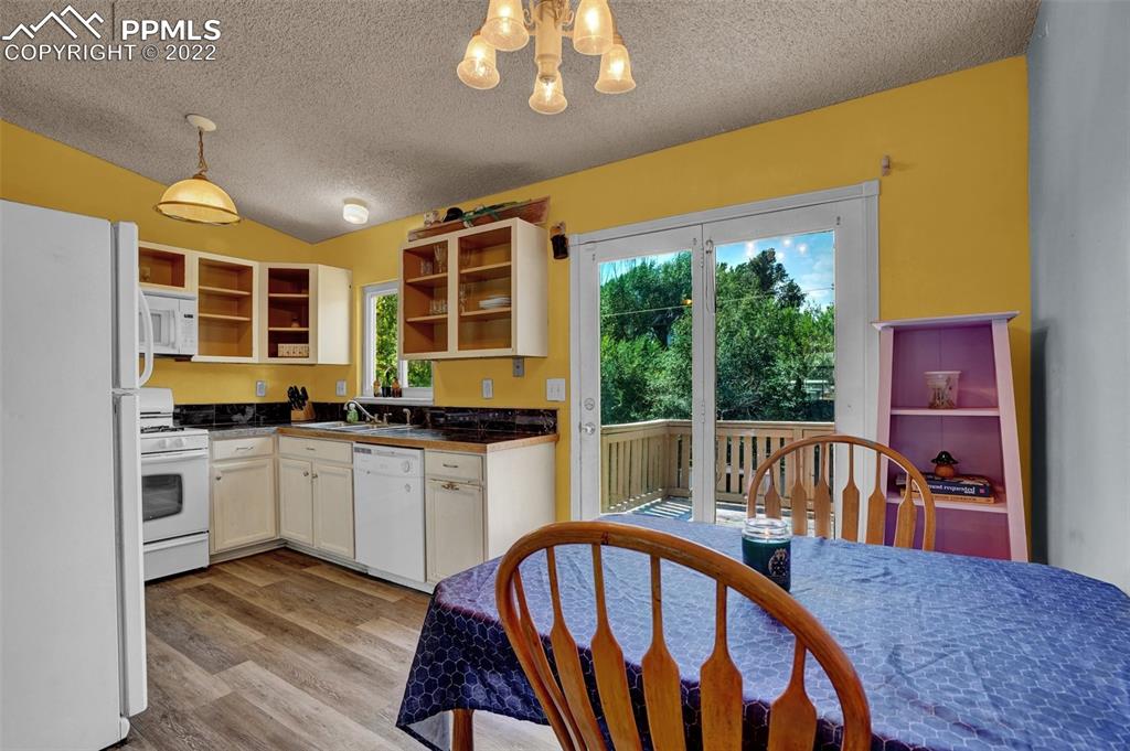 629 Blossom Field Road Fountain, CO 80817 - Photo 12 of 25 a view of a dining room with furniture window and wooden floor