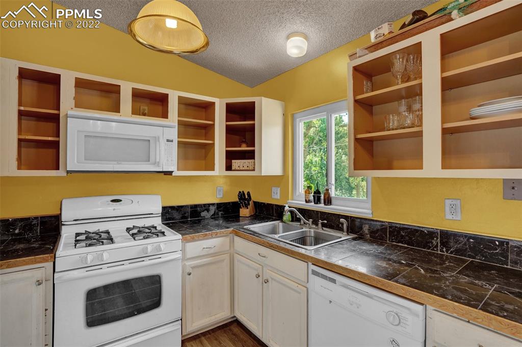 629 Blossom Field Road Fountain, CO 80817 - Photo 13 of 25 a kitchen with a sink and a stove