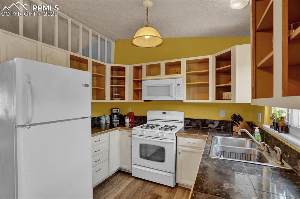 629 Blossom Field Road Fountain, CO 80817 - Photo 15 of 25 a kitchen with stainless steel appliances a stove a refrigerator and a cabinets