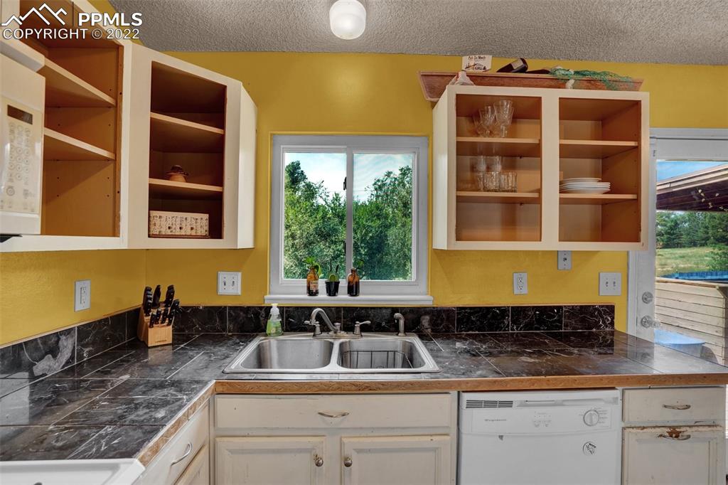 629 Blossom Field Road Fountain, CO 80817 - Photo 17 of 25 a kitchen with a sink and a window