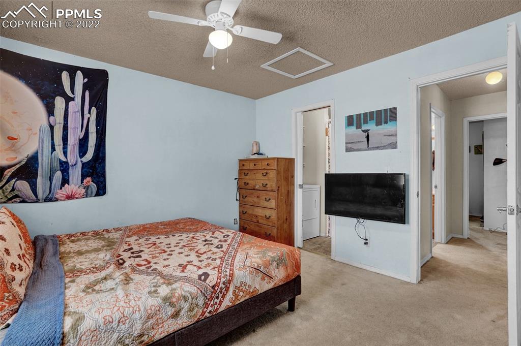 629 Blossom Field Road Fountain, CO 80817 - Photo 20 of 25 a bedroom with a bed and a flat screen tv