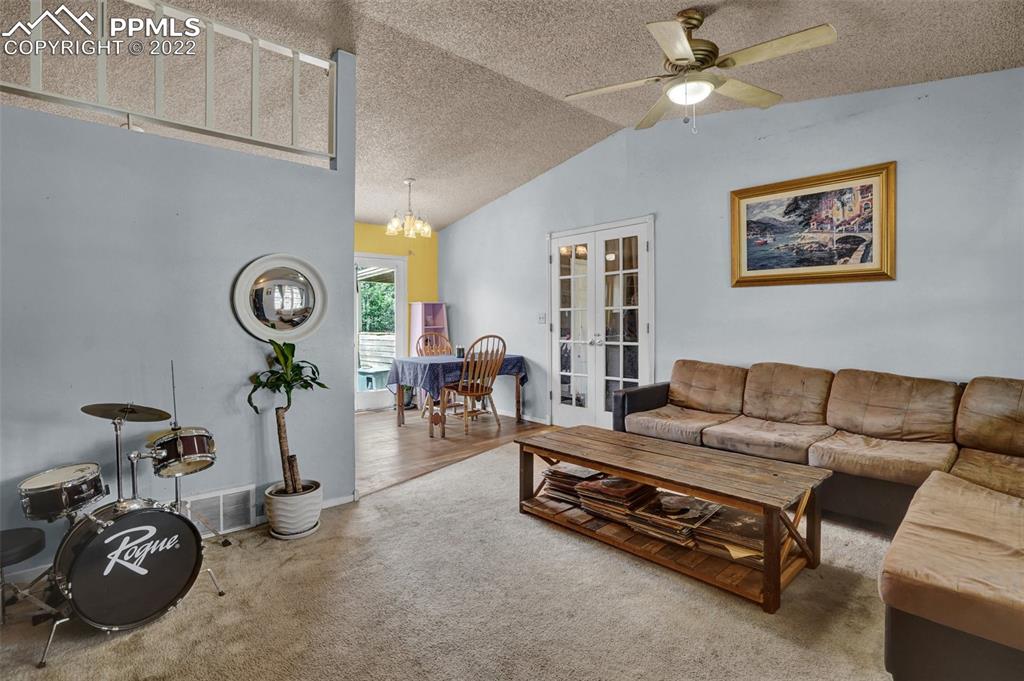 629 Blossom Field Road Fountain, CO 80817 - Photo 6 of 25 a living room with furniture a table and white walls