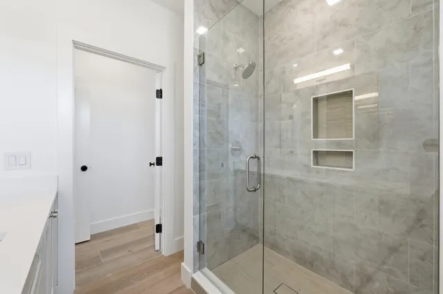 a view of a kitchen with kitchen island stainless steel appliances a sink and counter top space