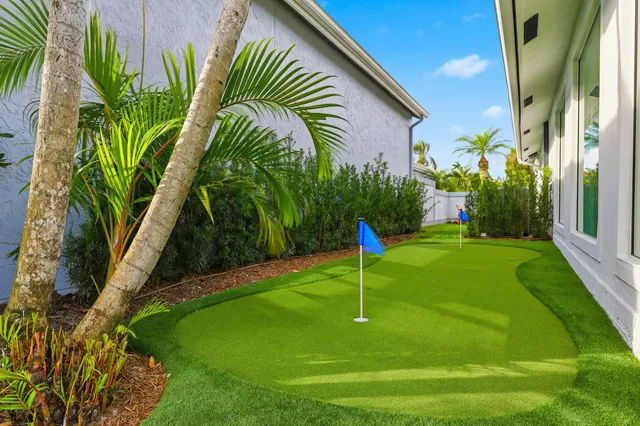 a house view with swimming pool in front of it