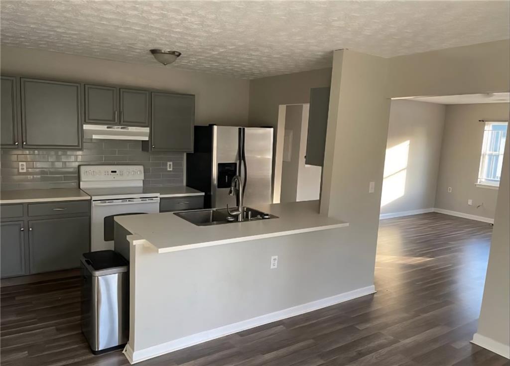 73 Polar Rock Road Southwest Atlanta, GA 30315 - Photo 4 of 16 a kitchen with a sink and wooden floor