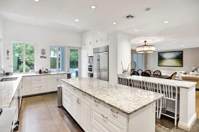 a large kitchen with kitchen island a sink stove and refrigerator