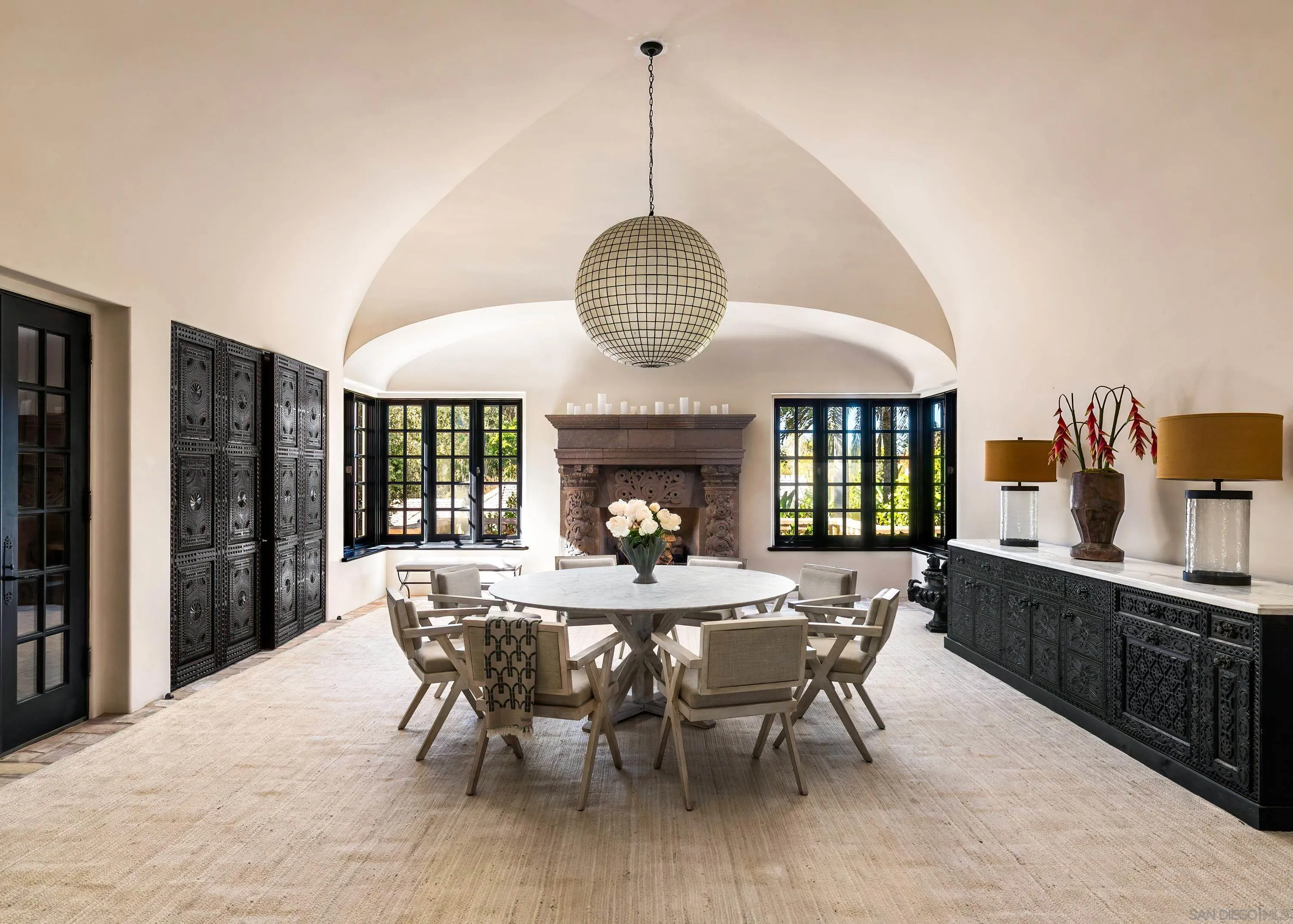 17116 Paseo Hermosa Rancho Santa Fe, CA 92067 - Photo 12 of 59 a dining room with wooden floor a chandelier a wooden table and chairs
