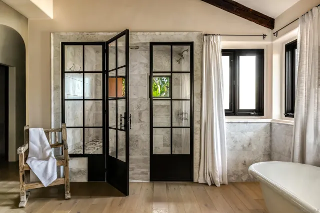 a view of a dinning room with patio furniture and potted plants