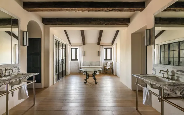 a view of a patio with table and chairs potted plants and palm tree
