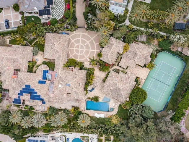 an aerial view of a house a garden and lake view