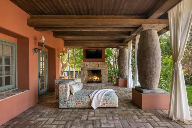 a view of house with patio entertaining space and garden
